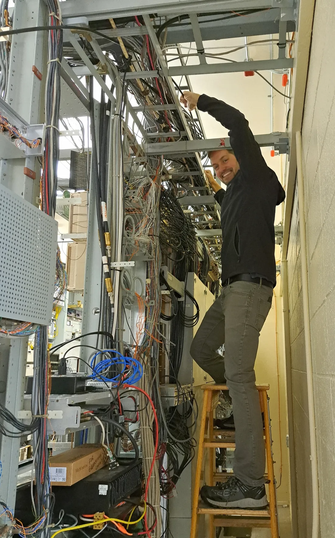 Wired by Design technician pulling cable through a wall